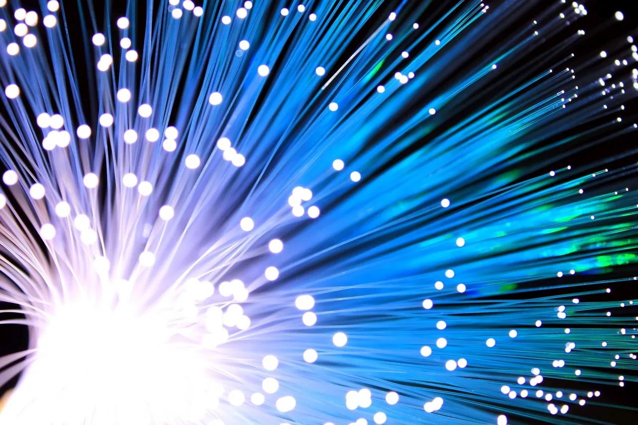 Strands of fibre-optic cable glowing blue and white